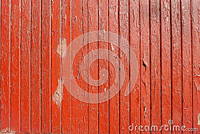 Wooden dark orange fence with narrow sluts and peeling paint Stock Photo