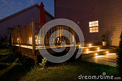 Wooden deck and patio of family home at night. Stock Photo