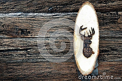 Wooden deer on wooden plank Stock Photo