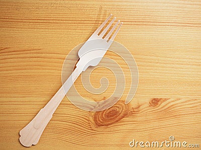 Wooden degradable fork on a wooden surface. Concept Ecology and recycle issue Stock Photo