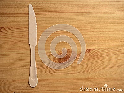 Wooden degradable knife on a wooden surface. Concept Ecology and recycle issue Stock Photo