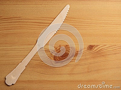 Wooden degradable knife on a wooden surface. Concept Ecology and recycle issue Stock Photo