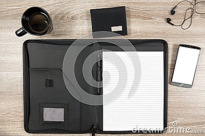 Wooden desk with smartphone, headphones, wallet, coffee mug and Stock Photo