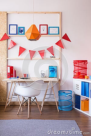 Wooden desk and stylish chair Stock Photo