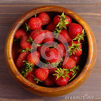 Wooden dish with strawberries. wood background, view from the top, square Stock Photo