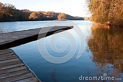 Wooden dock extends out into Atlanta's Chattahoochee River Stock Photo