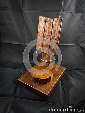 Wooden dock station or a stand for cellular mobile phone Stock Photo