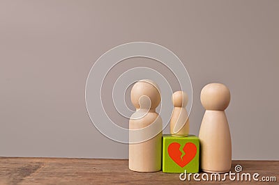 Wooden doll figures of family with break love heart. Concept of divorce Stock Photo