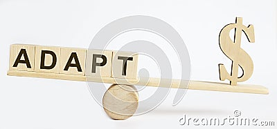 Wooden Dollar and the inscription ADAPT on wooden blocks. Balance Stock Photo