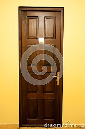 Wooden door with golden handle Stock Photo