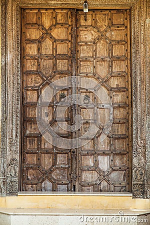 Wooden door with ancient floral patten. Wood carving technic. Stock Photo