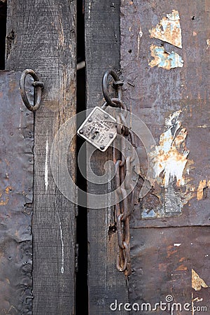 Wooden door with iron lock and chain, Editorial Stock Photo