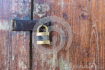 Wooden door with lock. Lock on an old wooden gate. Old padlock on closed doors. Stock Photo