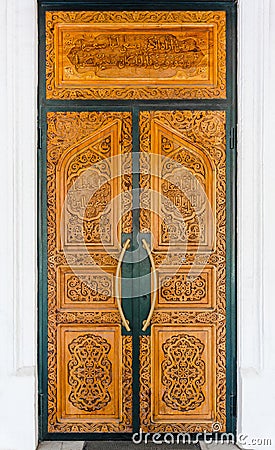 Wooden door into mosque Stock Photo