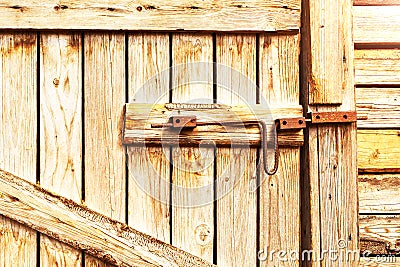 Wooden door to the barn or horse stall, lock on the door. Stock Photo