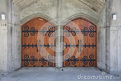 Wooden door way. Double wooden doors with ornamental iron design Editorial Stock Photo