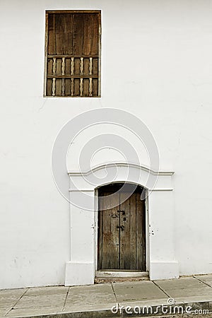 Wooden door and window in white colonial wall Stock Photo