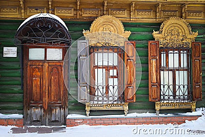 Wooden door and windows with carved accents Stock Photo