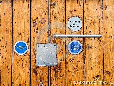 A wooden doors entrance secured and locked using an automatic system fob key. Editorial Stock Photo