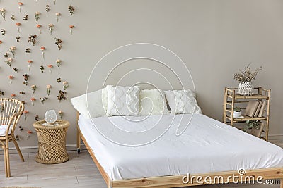 Wooden double bed with comfortable orthopedic mattress, white sheet Stock Photo