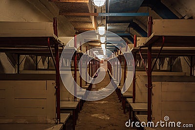 Wooden double-decker beds inside old abandoned soviet bomb shelter Editorial Stock Photo