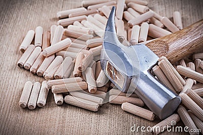 Wooden dowels and claw hammer top view image construction concep Stock Photo