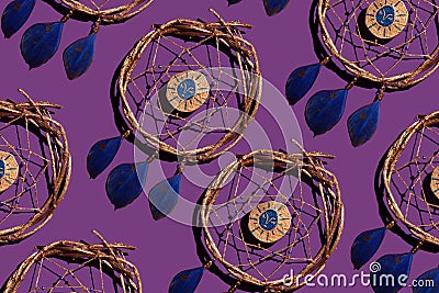 wooden dream catcher with feathers on a purple background Stock Photo