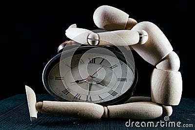 wooden dummy and analogic clock, time concept, puppet made of wood, art mennequin.Wooden Doll Stock Photo