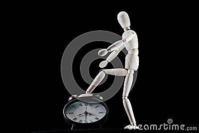 wooden dummy and analogic clock, time concept, puppet made of wood, art mennequin.Wooden Doll Stock Photo