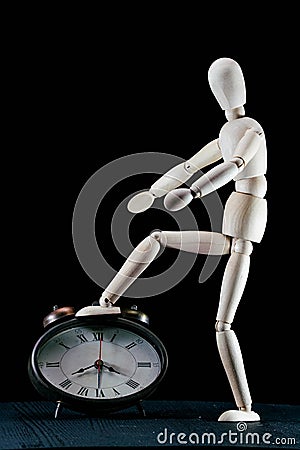 wooden dummy and analogic clock, time concept, puppet made of wood, art mennequin.Wooden Doll Stock Photo