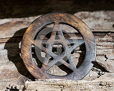 Wooden encircled pentagram symbol on fibrous tree bark. Five elements: Earth, Water, Air, Fire, Spirit. Stock Photo