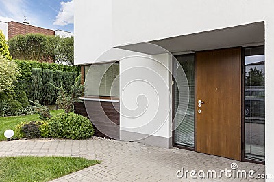 Wooden entrance door to modern house Stock Photo