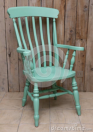 Wooden Farmhouse Grandfather Chair in green Stock Photo