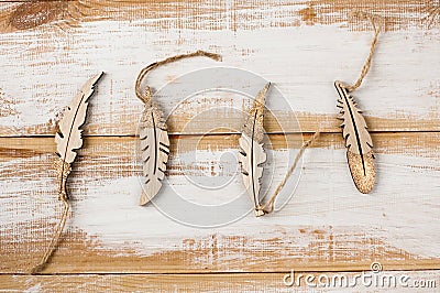 Wooden feathers toys for noel decoration on boards. Stock Photo