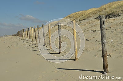 Wooden fence along the beach and dunes. Stock Photo