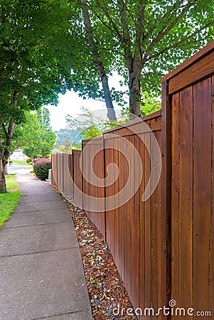 Wooden Fence along residential Neighborhood Sidewalk Stock Photo