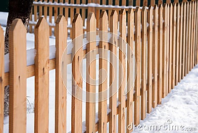 Wooden fence around garden in winter time Stock Photo