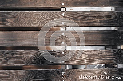 Wooden fence brown boards with gaps Stock Photo