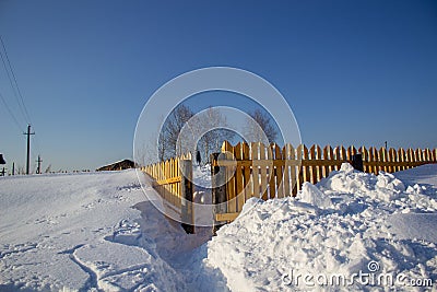 Wooden fence in the snow. Snow background Stock Photo