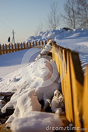 Wooden fence in the snow. Snow background Stock Photo