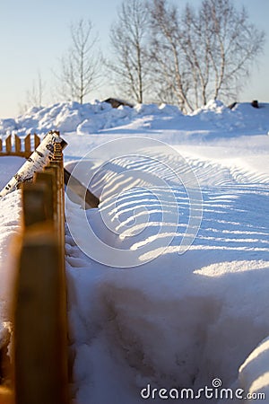 Wooden fence in the snow. Snow background Stock Photo