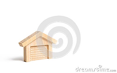 Wooden figure of a garage or warehouse. Inventions and innovations. Sale of garages and parking lots for cars. Stock Photo