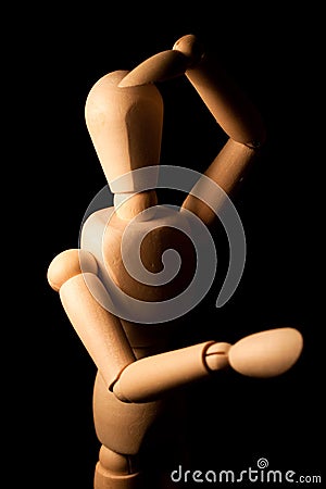 Wooden figure looking far away. Stock Photo