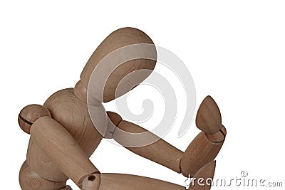 A wooden figure of a man holding his head, sitting in a thoughtful pose, heavy thoughts, anxiety, the problem of choice Stock Photo