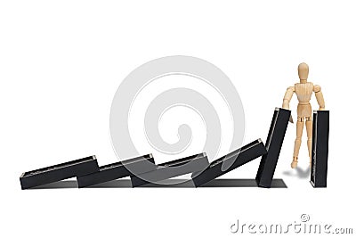 Wooden figure mannequin protect row of dominoes failing isolated on white background. Stock Photo