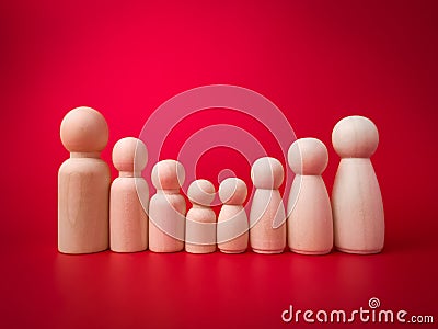 Wooden figures big family lined up according to their respective heights Stock Photo