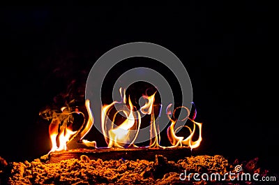 Wooden figures 2018 are burned in a flame. Conceptual photo end of the year. Stock Photo