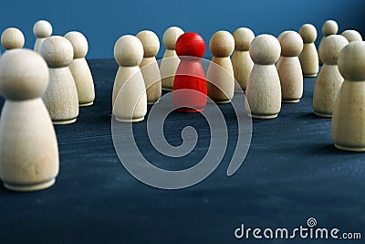 Wooden figures and one red figure. Be different. Stand out from the crowd Stock Photo