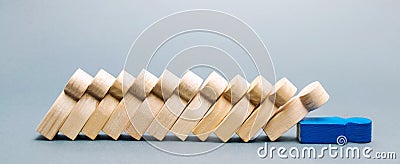 Wooden figures of people. Domino business concept. The leader does not stop the fall of employees. Weak link. Unreliable boss. Stock Photo