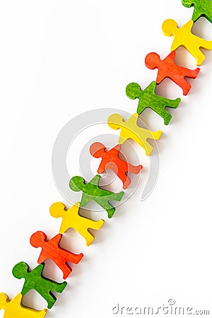 Wooden figures of people on yellow background top view. Teamwork, teambuilding concept Stock Photo